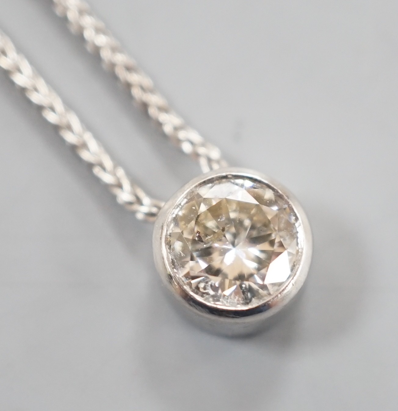 A modern Italian 18ct white gold and collet set solitaire diamond pendant necklace, 38cm, gross weight 3.8 grams